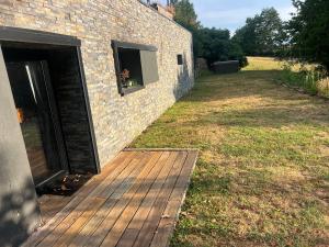 a wooden ramp leading to a building with a window at Les Angères in Saint-Martin-d'Uriage