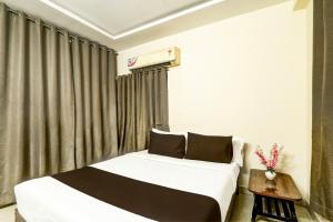 a bedroom with two beds and a window at Hotel O Vyb Hotels in Hyderabad