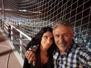 a man and a woman standing in front of a goal at Brilu in Savona