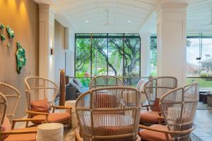 a room with a bunch of chairs and windows at Exclusive Kauai Beachfront Resort with Dining, Bar, Spa, Pool & Waterslide in Lihue +153 photos