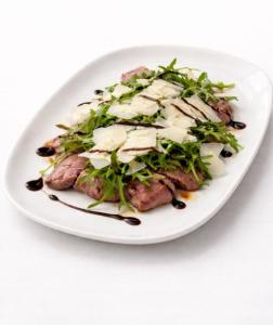 a white plate of food with meat and vegetables at La Stazione in Cordovado
