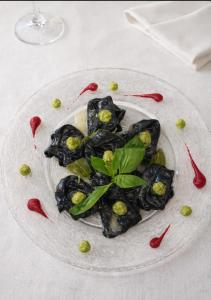 a plate of food with vegetables on a table at La Stazione in Cordovado