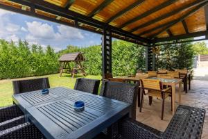a patio with tables and chairs and a gazebo at Pensiunea ANDREI OCNELE MARI in Râmnicu Vâlcea