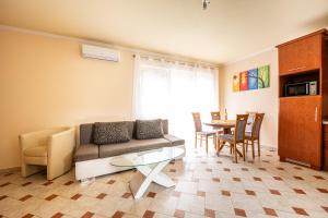 a living room with a couch and a table at Gere Apartment de Luxe in Harkány