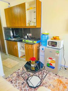 a small kitchen with a stove and a microwave at Bohen BnB 2 in Ongata Rongai 