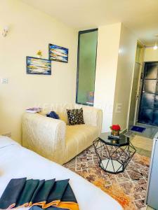 a living room with a couch and a table at Bohen BnB 2 in Ongata Rongai 