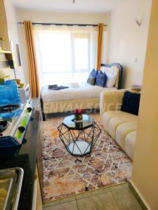 a living room with a couch and a table at Bohen BnB 2 in Ongata Rongai 