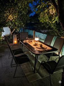 a table with chairs and a candle on a patio at A frame ti i ja in Smederevska Palanka +10 photos