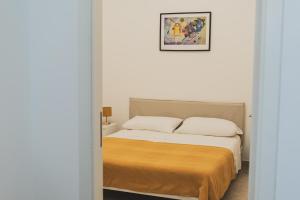 a bedroom with a bed and a picture on the wall at Villa Zoe in Specchiolla