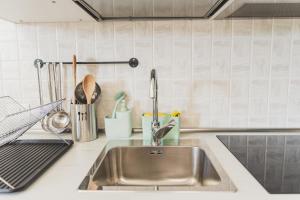 a kitchen counter with a sink and utensils at Villa Zoe in Specchiolla +62 photos