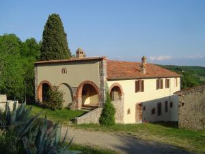 a large white building with a red roof at Podere Pancoli in Massa Marittima