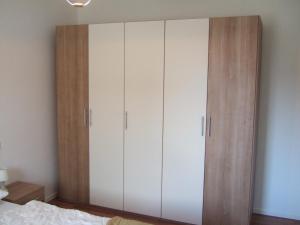 a large white cabinet in a bedroom at Ferienhaus Lutowsee in Grammertin