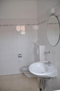 a white bathroom with a sink and a toilet at Ferienhaus Lutowsee in Grammertin