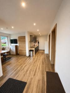 an empty apartment with a kitchen and a living room at Apartment Kaiblingblick in Haus im Ennstal +6 photos