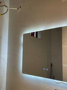 a mirror on a wall in a bathroom at Bellwether Heights Kyanja in Kampala