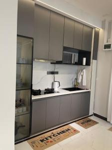 a kitchen with gray cabinets and a counter top at Bellwether Heights Kyanja in Kampala +56 photos