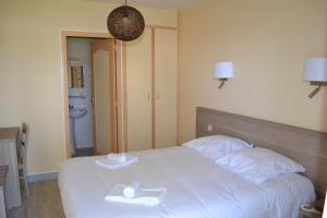 a bedroom with a bed with two white towels on it at Le Lanthenay in Romorantin