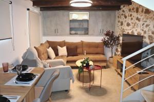 a living room with a couch and a tv at Aethra Seaview Suites in Kerames +36 photos