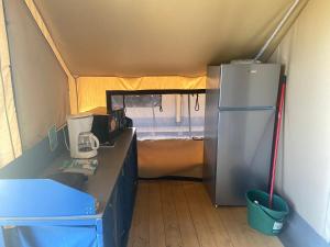 a kitchen with a refrigerator in a tent at Ohana Apartments Camping Tiglio in Sirmione +17 photos