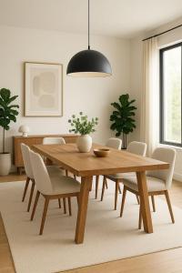 a dining room with a wooden table and chairs at Ste hub loges in Parakou