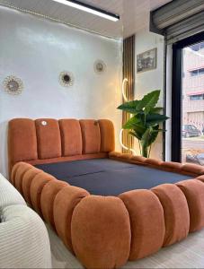 a large couch in a living room with at Ste hub loges in Parakou