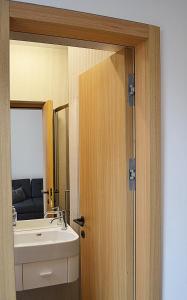 a bathroom with a sink and a mirror at Moravská 15 Apartments in Karlovy Vary