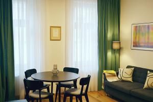 a living room with a table and chairs and a couch at Moravská 15 Apartments in Karlovy Vary
