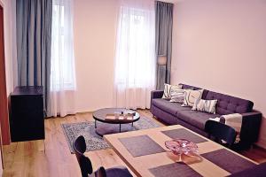 a living room with a couch and a table at Moravská 15 Apartments in Karlovy Vary