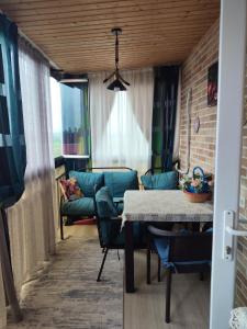 a living room with a table and a couch at Deako in Kobuleti