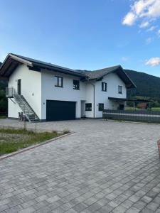 a large white house with a large driveway at Apartment Kaiblingblick in Haus im Ennstal