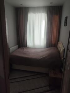 a bed in a small room with a window at Deako in Kobuleti +6 photos
