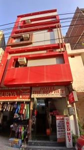a building with a red roof and a store at Hotel Red Hut Chandigarh railway station in Zirakpur