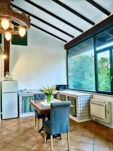 a kitchen with a table and chairs and a large window at Il giardino delle cince in Borgo Ticino