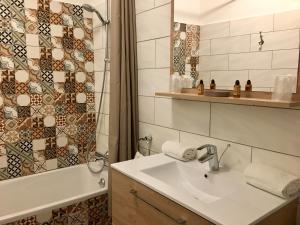 a bathroom with a sink and a shower and a tub at Le Magnan in Avignon