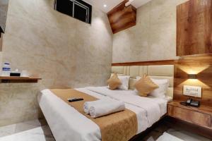 a bedroom with a large bed in a room at Hotel Omega in Mumbai