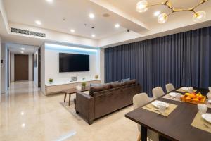 a living room with a couch and a table at Morich Penthouse Jakarta in Jakarta