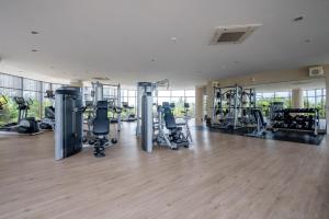 a gym with treadmills and machines in a building at Morich Penthouse Jakarta in Jakarta
