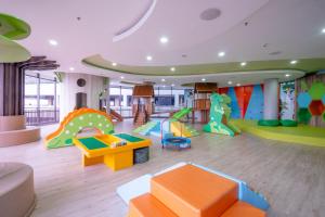 a childrens play room with a bunch of play equipment at Morich Penthouse Jakarta in Jakarta