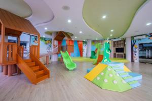 a childrens play room with a slide and a playground at Morich Penthouse Jakarta in Jakarta