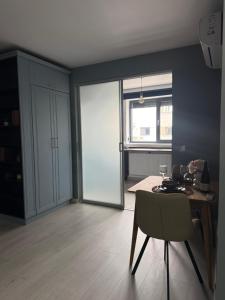 a dining room with a table and a chair at Blue Oasis Apartment - Hils Brauner in Bucharest