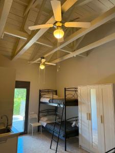 a room with two bunk beds and a ceiling fan at Calliopi's studio in Plytra +23 photos