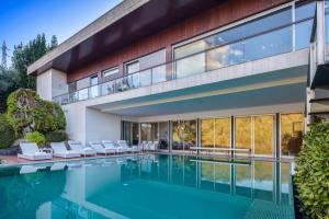 an exterior view of a house with a swimming pool at Infinity Villa Cavez - Luxury Retreat in Moimenta