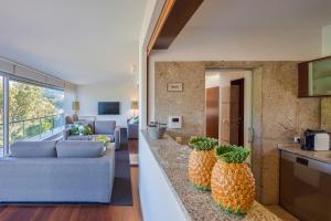 a living room with two pineapples on a counter at Infinity Villa Cavez - Luxury Retreat in Moimenta +17 photos