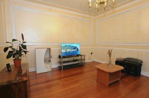 a living room with a television and a table at HOLIDAY's HOUSE in Semedela