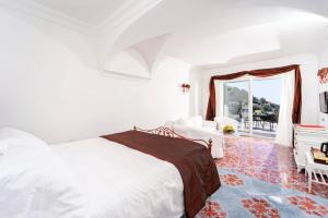 a white bedroom with a bed and a window at Regina Cristina in Capri +48 photos