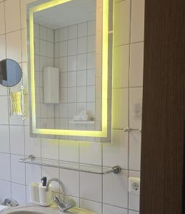a bathroom with a mirror and a sink at Simple Modern Apartment in Duisburg
