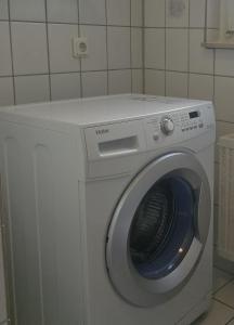 a white washing machine in a room with at Simple Modern Apartment in Duisburg