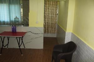 a table and a chair in a room with a table and a window at Dipankar House in Tezpur +85 photos