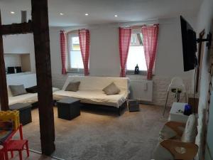a bedroom with a bed and two windows at Ferienhaus Schönek in Warmensteinach