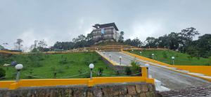 a building on top of a hill with a building on it at Hame Lana Resort in Mawlynnong